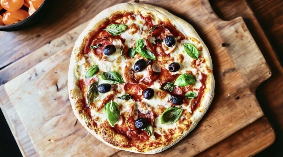 Domowa pizza z salami przygotowana na tradycyjnym cieście podana z domowym sosem pomidorowym z dodatkiem salami, czosnku, oliwek a także świeżej bazylii.