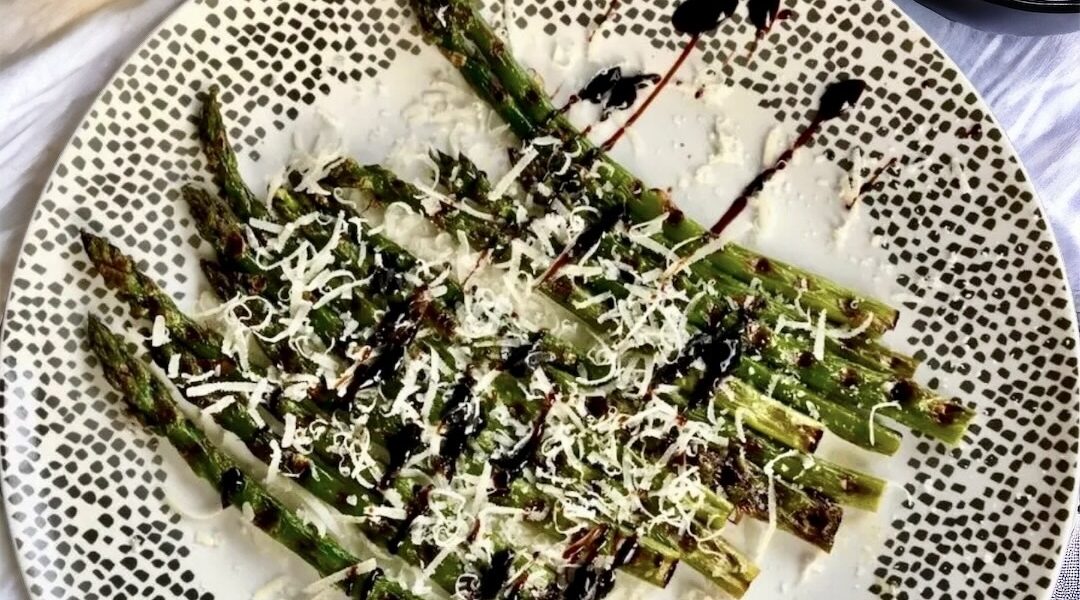Szparagi zielone skropione oliwą, a następnie krótko pieczone i podane z octem balsamicznym i startym parmezanem.